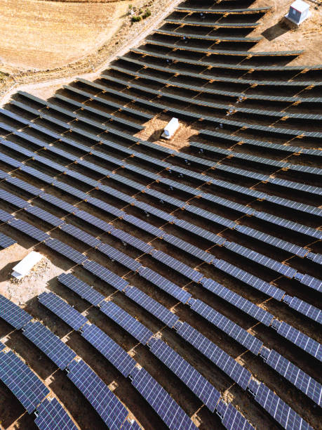 istock Harvesting Sunlight: Aerial View of Solar Panel Site Energy Farm 1965011385
