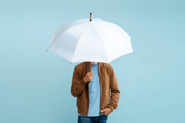 Man holding white stylish umbrella isolated on blue background