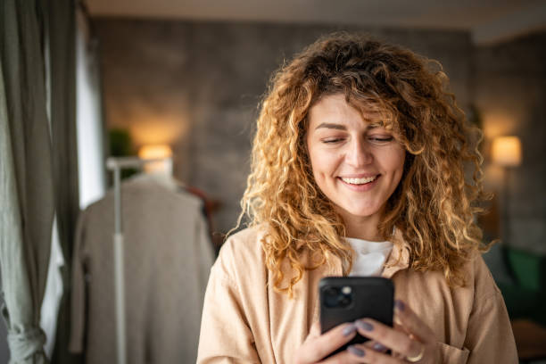 istock Happy beautiful young woman using smartphone typing messages 1965065970