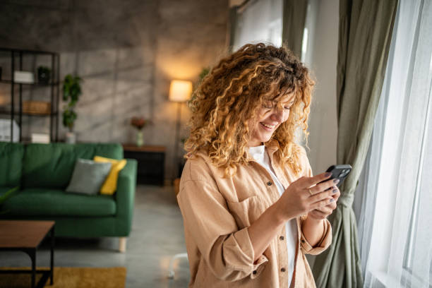 istock Happy beautiful young woman using smartphone typing messages 1965066502