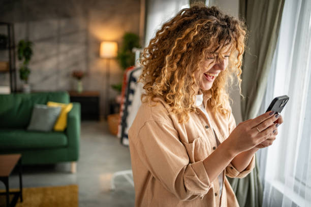 istock Happy beautiful young woman using smartphone typing messages 1965066509