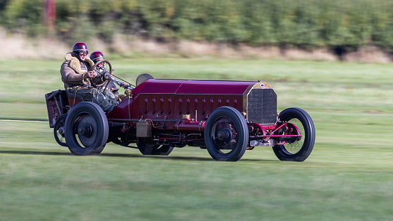 Old Warden, UK - 2nd October 2022: Vintage 1905 Fiat Isotta Fraschini 200 HP racing car being driven at speed along grass runway