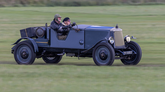 Old Warden, UK - 2nd October 2022: Vintage 1929 Armstrong Siddeley car being driven at speed along grass runway