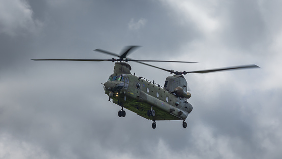 Cosford, UK - 12th June 2022: A Boeing Chinook military helicopter of the RAF hovers close to the ground