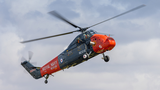 Fairford, UK - 14th July 2022: A vintage Westland Wessex helicopter of the Royal Navy rescue service hovering low over ground