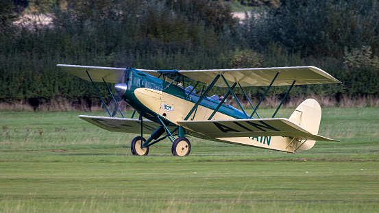old Warden, UK - 2nd October 2022: Vintage 1929 Parnall Elf biplane landing on grass