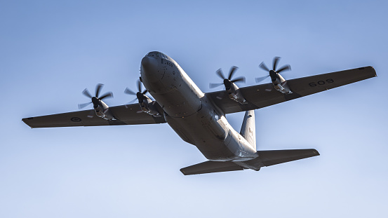 Fairford, UK - 14th July 2022: A Lockheed C-130 Hercules transport aircraft flying low above the ground