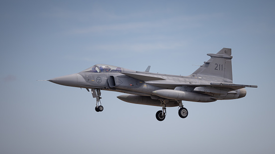 Fairford, UK - 14th July 2022: A Saab Gripen, Swedish built fighter jet, in flight with wheels down coming into land.
