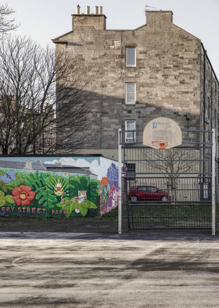 basketball backboard with the orange hoop metal ring at outdoor basketball courts in the park. - concrete park city cityscape ストックフォトと画像