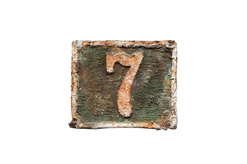 Old retro weathered cast iron plate with number 7 closeup isolated on white background