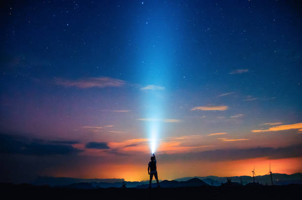 Light the starry sky A person holding a flashlight under the starry sky spectacular view stock pictures, royalty-free photos & images