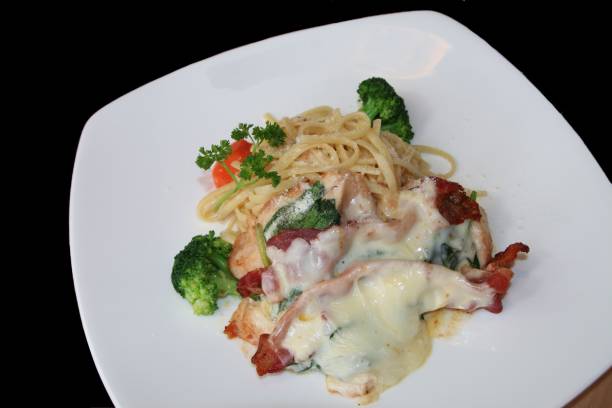 istock Spaghetti carbonara with bacon and broccoli on a white plate. 1965095312