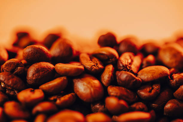 Roasted coffee beans with smoke and fire background. Close up,