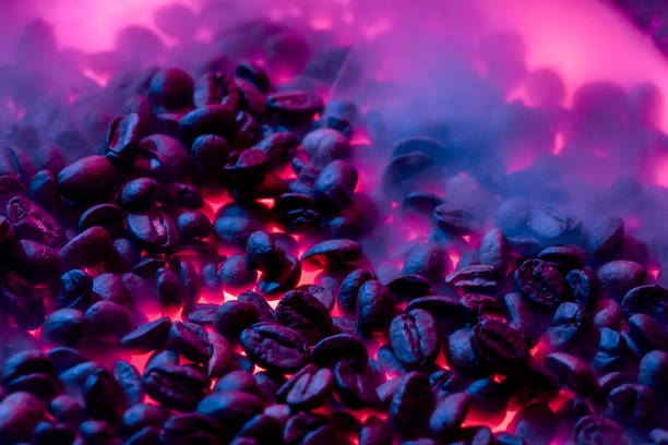 Roasted coffee beans with smoke and fire background. Close up,