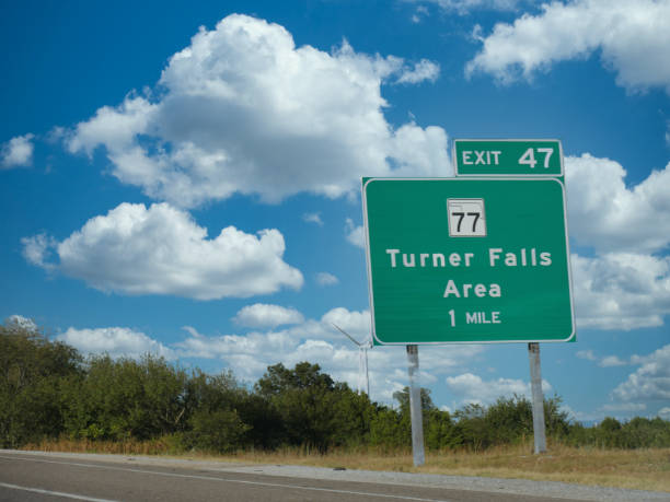 istock Roadside sign along Interstate 35 showing Turner Falls exit at the Arbuckle Mountains, Oklahoma. 1965101813