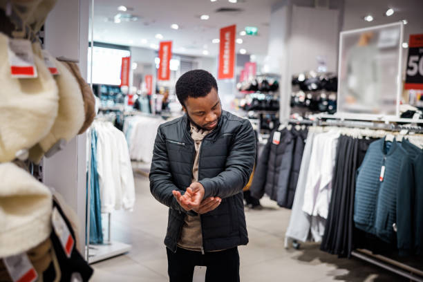 istock Man shopping new jacket for winter in store 1965117586