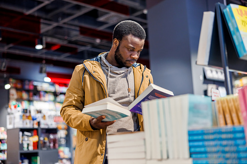 African American man chooses books in bookstore