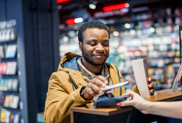 istock Man buying a book in bookstore 1965119777