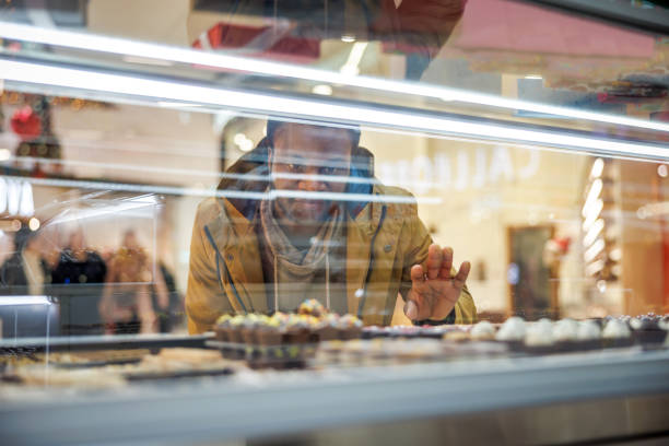 Close-up of colorful stuffed buns lined up to display their diverse fillings chocolate , butter sugar , and taro cream , highlighting the variety found in street food culture.