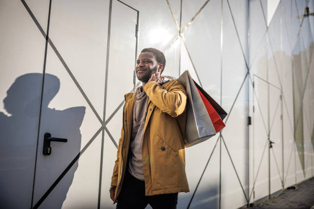 istock Smiling man carries shopping bags 1965121401