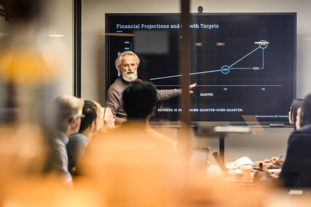 istock Senior man presenting report in meeting room 1965145030