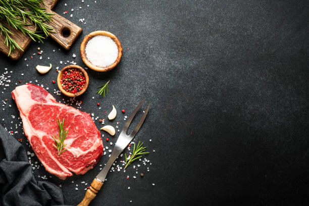 istock Beef steak ribeye with spices and herbs on black background. 1965182881
