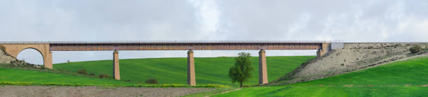 istock Ancient Viaduct Bridge Over Green Countryside 1965183953