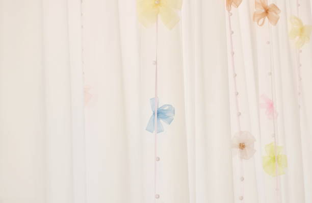 close up of pink curtain decorating hanging mobile colorful ribbon bow background and background