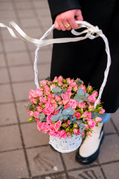 istock Female hands hold a basket with different flowers 1965203312