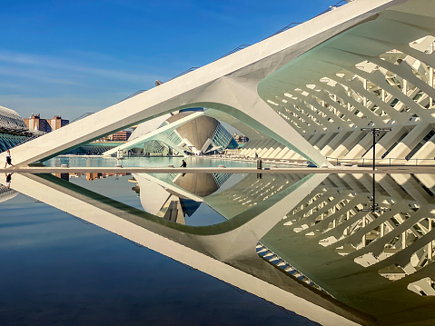 Valencia, Spain - January 25, 2024: Reflected building on water in the City of the Arts and the Sciences. This is the most important tourist attraction in the city with lots of visitors every year. The project began its construction in July 1996