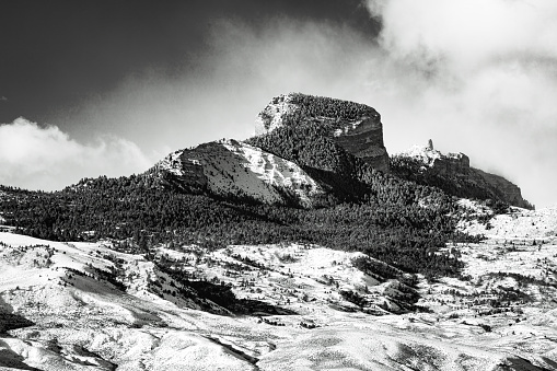 Retro monochrome landscape of the snow-covered Hewart Mountain and sagebrush prairie hills of northwest Wyoming, USA in winter.