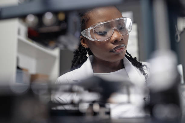 istock Female Technician Wearing Safety Glasses in Laboratory 1965289637