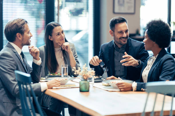 istock Group of business persons having lunch together 1965304573