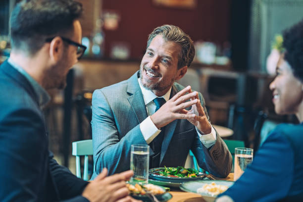 istock Businessman talking to colleagues during dinner in a restaurant 1965304587