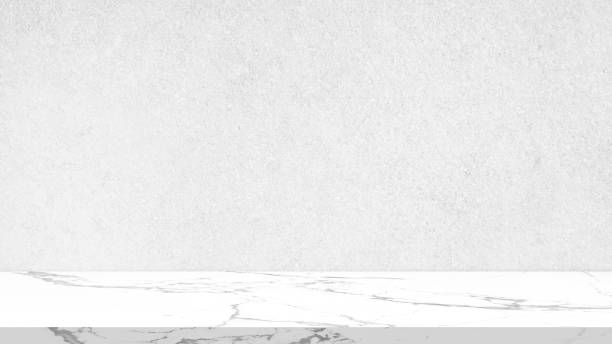 istock carrara marble table with stucco wall texture at background. suitable for product presentation or advertising backdrop. display, and mock up background. 1965338924