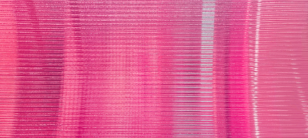 pink glass sheet wall or corrugated wall pattern texture use as background. frosted wave glass in horizontal line pattern in the translucent and polished effect. background for Valentines concept.