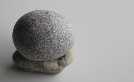 Smooth Round Stone On Another Porous Stone