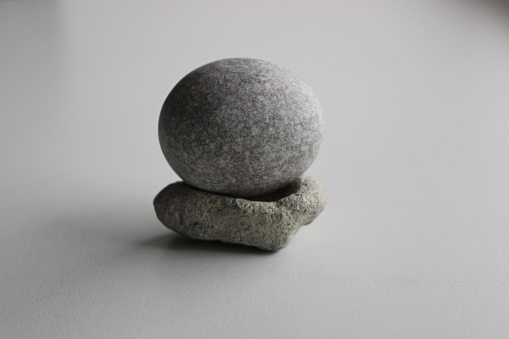 Single Zen Stone On White Surface Stock Photo For Backgrounds