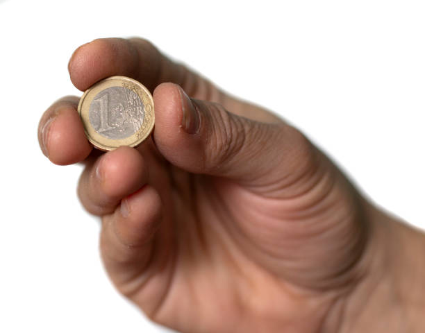istock One Euro Coin Hold by Man Hand, on White Background 1965381995