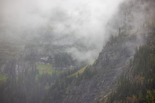 Fog and rain creating moody conditions in the Mountains of Glacier National Park, Montana.