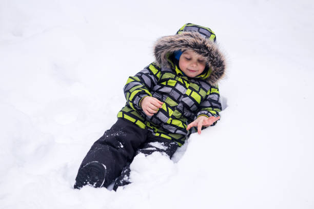 istock little child playing in the snow in winter 1965394548