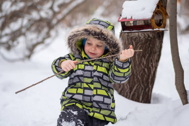istock little child walking in winter snowy park 1965396110