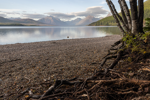 peaceful afternoon in glacier Montana from the shores of McDonald Lake and the mountains in the backgroun.