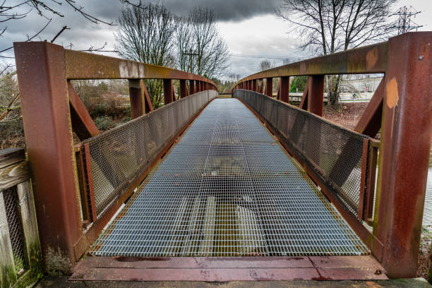Close-up shot of an old metal bridge spans the Green River in Kent, Washington.