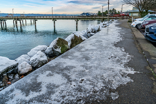 Ice covers a walkway near a pier in Ruston, Washington.