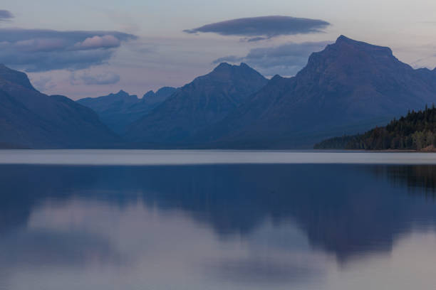 peaceful afternoon in glacier Montana from the shores of McDonald Lake and the mountains in the backgroun.