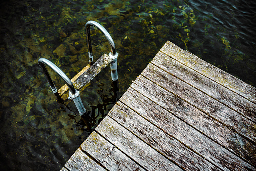 An unoccupied dock featuring a submerged metal ladder