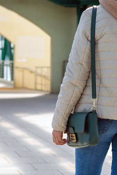 istock a woman with a handbag on her shoulder walks along the passage 1965441292