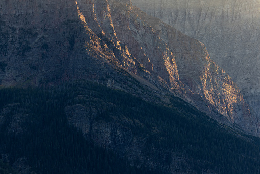 last light on a rocky mountain as the sunsets in Glacier National Park, Montana.