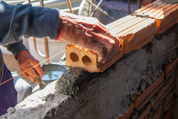 A Builder makes a Blue Brick Kerb on a domestic property in the UK